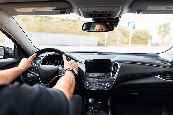 Conducteur et tableau de bord vus depuis l’arrière d’une voiture — illustration VTC : Wallis-et-Futuna
